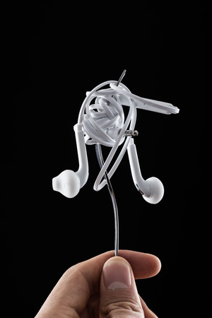 Earphone on fork on black backgroundの写真素材