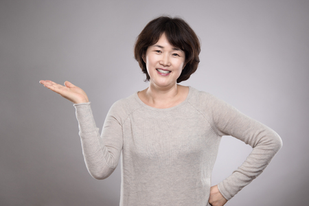 Asian middle-aged female studio portrait - isolatedの写真素材