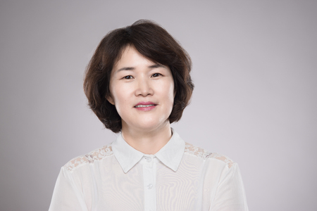 Asian middle-aged female studio portrait - isolatedの写真素材