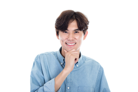 Studio portrait of a handsome asian man having a happy worryの写真素材