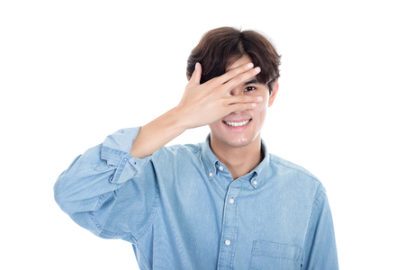 Portrait of Asian man covering half of his face with handsの写真素材