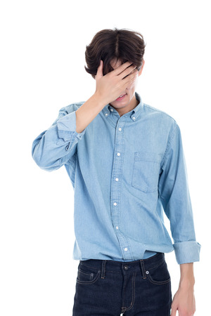 Portrait of Asian man covering his face with handsの写真素材