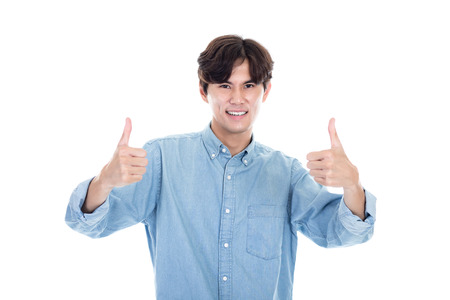 Studio portrait of Asian man expressing successの写真素材