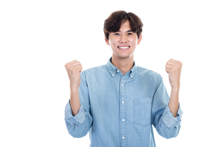 Studio portrait of Asian man expressing successの写真素材