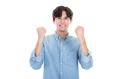 Studio portrait of Asian man expressing successの写真素材