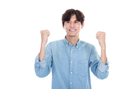 Studio portrait of Asian man expressing successの写真素材