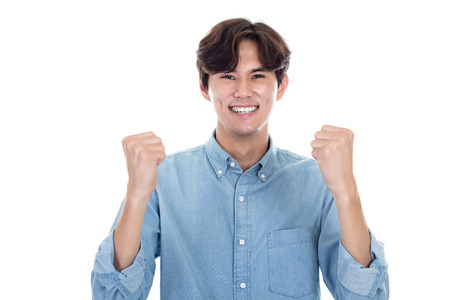 Studio portrait of Asian man expressing successの写真素材