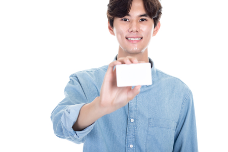 Studio portrait of an Asian man holding a cardの写真素材