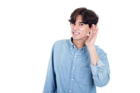 Studio portrait of an asian man listeningの写真素材