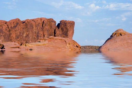 Red cliffs, blue sky and a blue lake.の写真素材