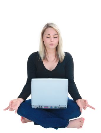 Beautiful young woman in lotus yoga position with laptop on lap.の写真素材