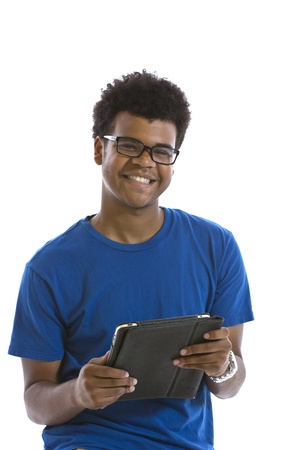 Handsome smiling young African American man holding electronic tablet standing in front of white backgroundの写真素材