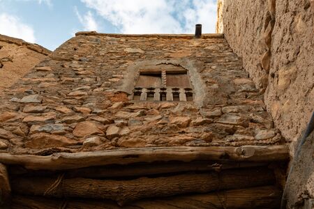 Upward view to a window in ruins of Misfat al Abriyeen village in Omanの写真素材