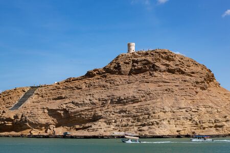 Traditional watchtower on hill in Al Ayjah, opposite lagoon of Sur in Omanの写真素材