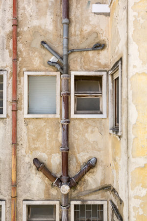 Exposed external sewerage pipes of old apartment house in Lisbon, Portugal
