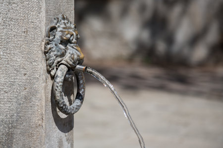 Lions head as a water outlet at the drinking well, Venice, Italyの写真素材