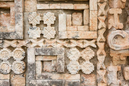 Ornate decoration at wall of Mayan Grand pyramid ruins at Uxmal, Yucatan, Mexicoの写真素材