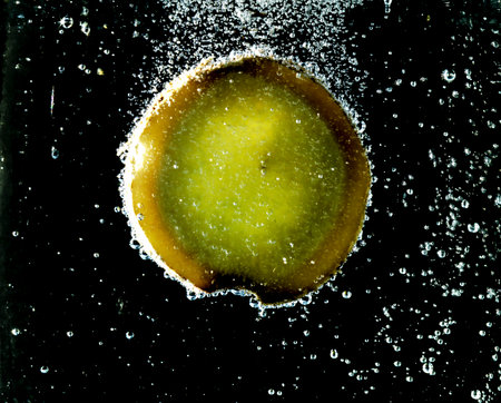 Kiwi fruit in sparkling water with bubblesの写真素材