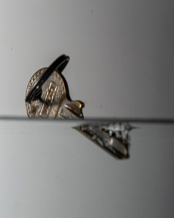 key with key ring drops with splash in clear water