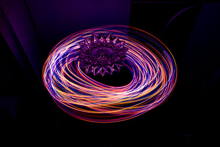 Painting with light on a mirror with small colored lamps and a glass object.