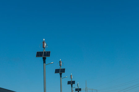 Street lamp with solar and wind energy on the roadside and blue sky in the background