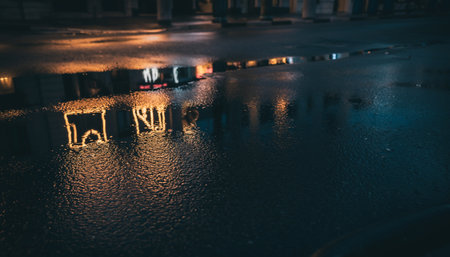 Illuminated chairs floating on a body of water at duskの素材
