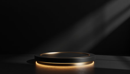 A golden ring illuminated by a spotlight on a dark surfaceの素材