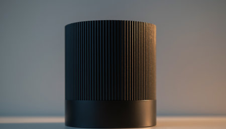 A sleek black cylindrical object with a ribbed texture on a neutral backgroundの素材