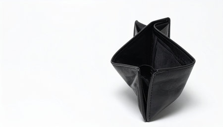Black origami paper folded into a geometric shape on a white background with subtle shadow
