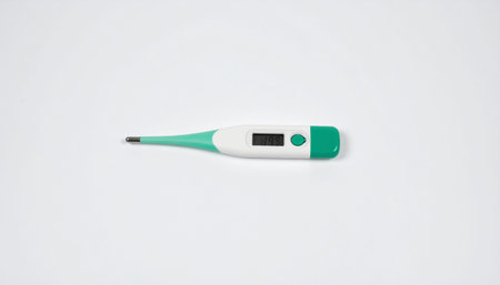 A digital thermometer with a white body and green accents on a plain white background.
