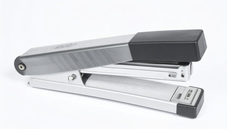Silver office stapler with black accents on a white background