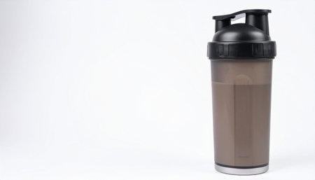 A protein shaker bottle filled with chocolate drink on a white background