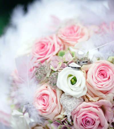 Wedding rings over the bride bouquetの写真素材