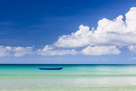 Fisher boat and clear turquoise water at daytimeの写真素材