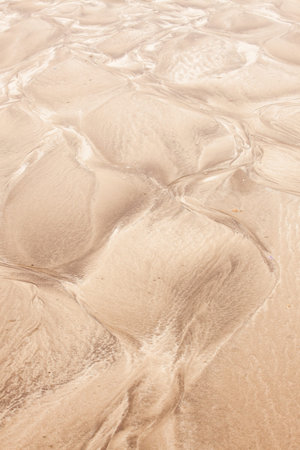 Natural sand patterns in beach at low tide