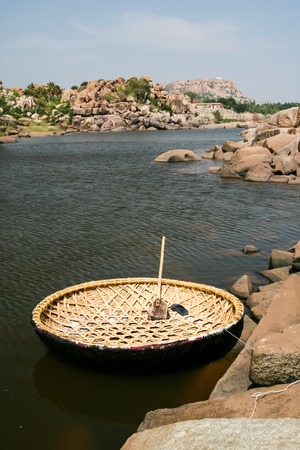 Traditional round boat in river hampi karnataka indiaの写真素材
