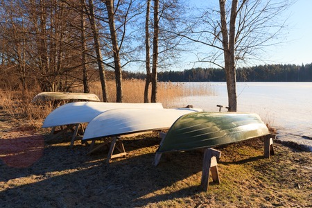 Rowboats in winter storage at sunny spring morningの写真素材