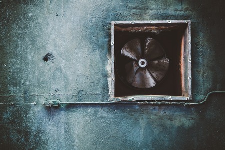 Air conditioning duct and rusted fan on abandoned factory grunge ceilingの写真素材