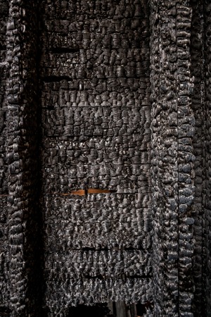 Burnt broken wood wall background textureの写真素材