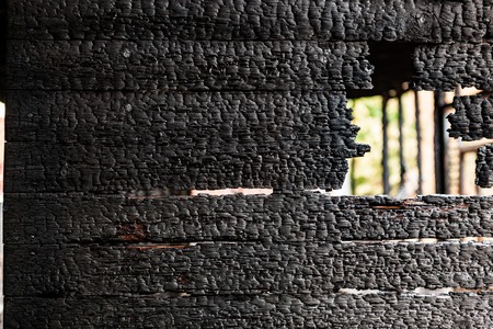 Burnt broken wood wall background textureの写真素材