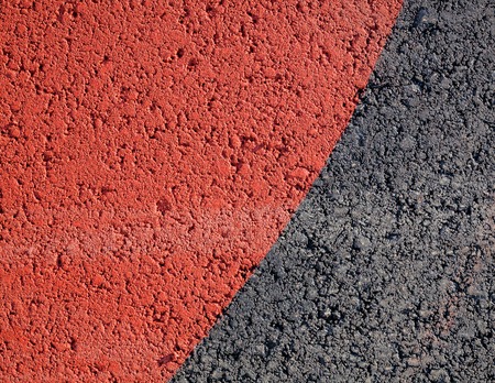 Red paint in asphalt texture backgroundの写真素材