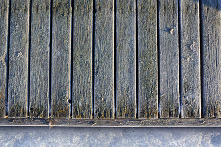 Frozen planks of old pier at sunny winter morningの写真素材