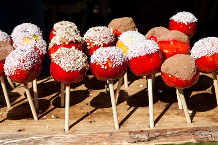 Sweet candy apples for sale in market sunny outdoorsの写真素材