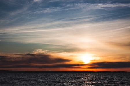 Calm sunset and clouds over lake in finlandの写真素材