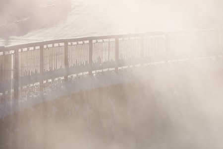 Railing in cold winter morning fogの写真素材