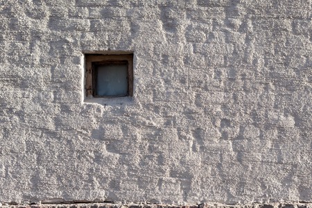 Plastered brick wall and small window outsideの写真素材