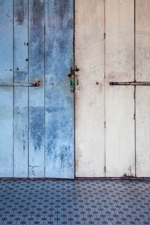 Worn messy old wooden door lockedの写真素材