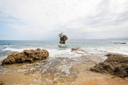 Beach and rock islet in Manzanillo Costa Ricaの写真素材