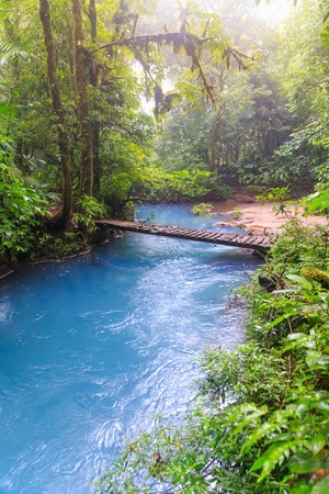 Rio celeste and small wooden bridgeの写真素材