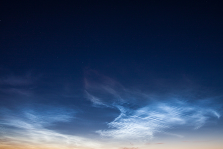 Noctilucent clouds at night skyの写真素材
